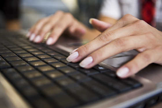 Woman typing on laptop, selective focus, canon 1Ds mark III